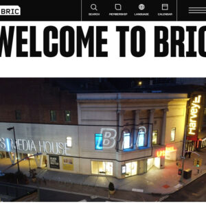 BRIC Arts Media House building at night, illuminated with bright signage including "BRIC" and "Harvey," located on a street corner with visible sidewalks and streetlights.