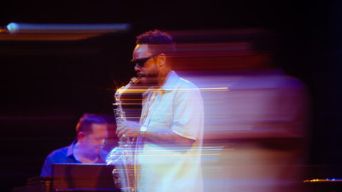 Terrace Martin playing a saxophone