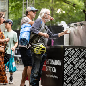 An elderly man filling water at the hydration station