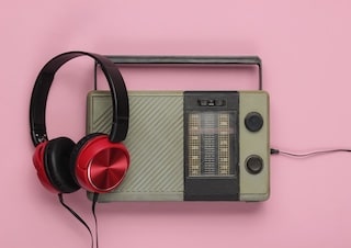 https://bricartsmedia.org/wp-content/uploads/2025/08/retro-radio-receiver-oldfashioned-wired-headphones-pink-pastel-background-1-min.jpg