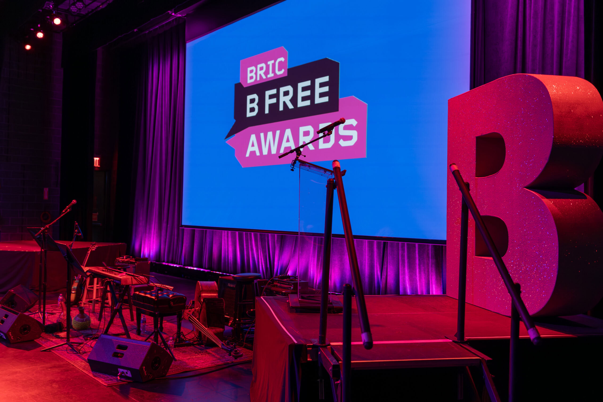 Stage setup for BRIC B Free Awards with large screen displaying event logo and purple lighting.